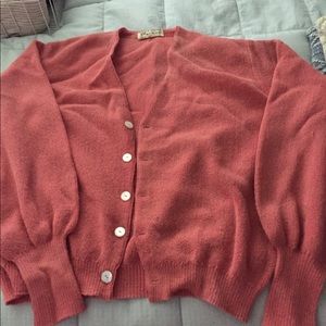 Two men’s golf sweaters. 1 coral and 1 navy blue